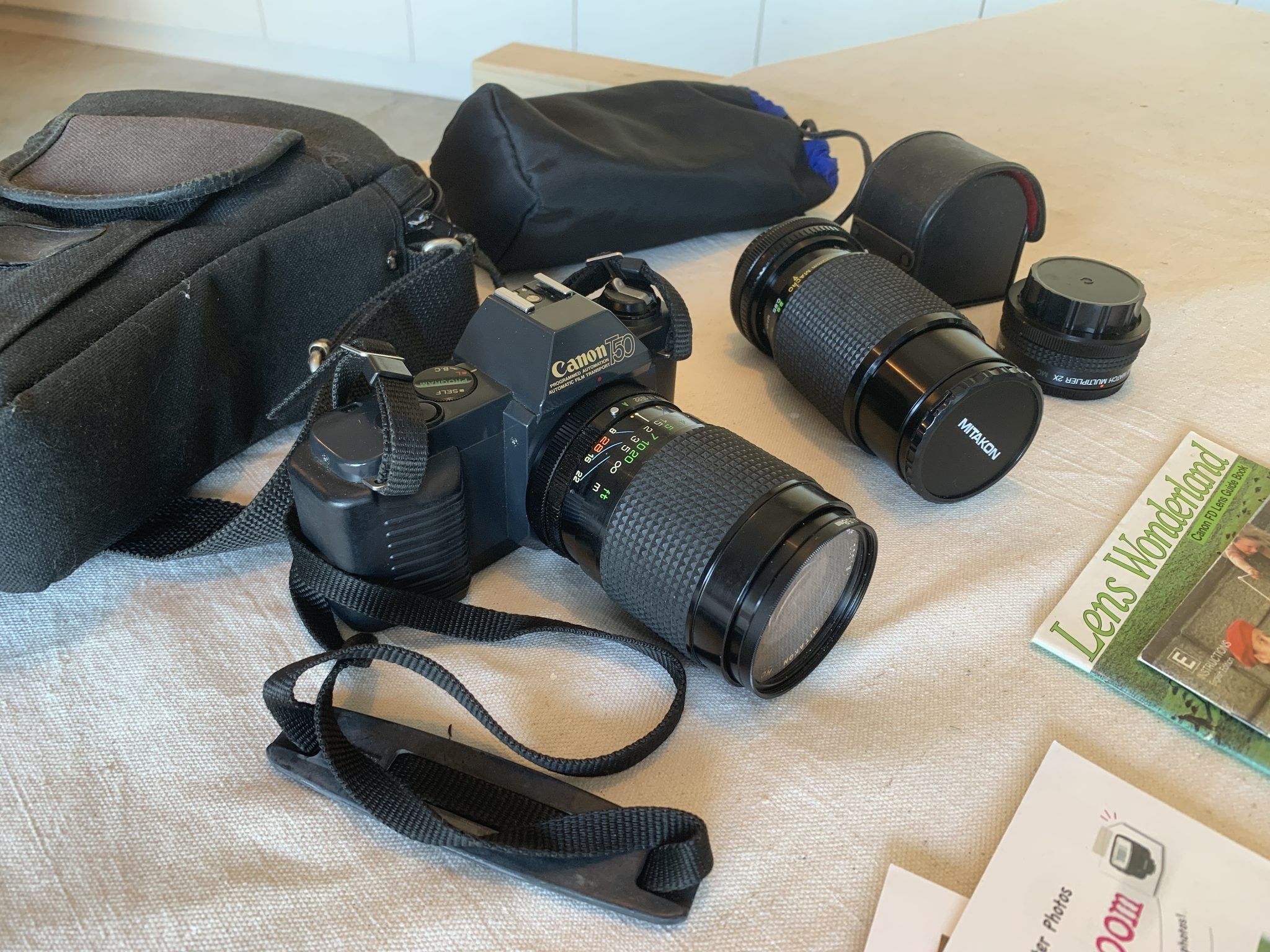 Canon T50 SLR Camera with additional lenses and OEM manuals
