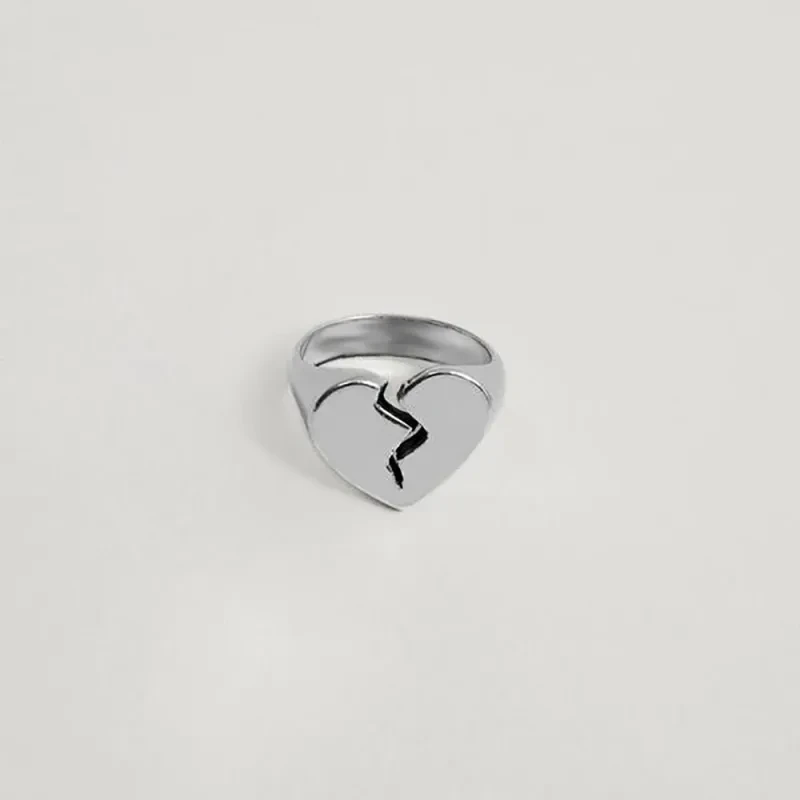 Make a statement with the Creative Hip Hop Fashion Heart-shaped Gold and Silver Color Ring. This bold, eye-catching piece combines modern design with a touch of elegance, perfect for those who love to stand out.