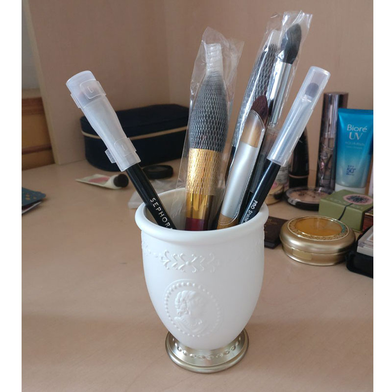 Embossed makeup brush tube