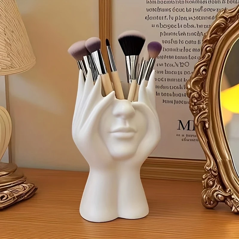 Add elegance to your vanity with the Elegant Human Form Art Makeup Brush Holder. Durable, shatterproof polyresin with a unique hand design, perfect for storing makeup brushes or office supplies.